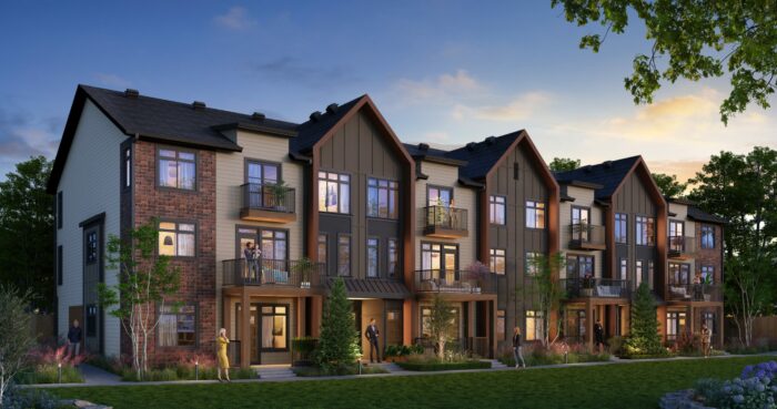 Modern townhomes at dusk with people enjoying the evening.