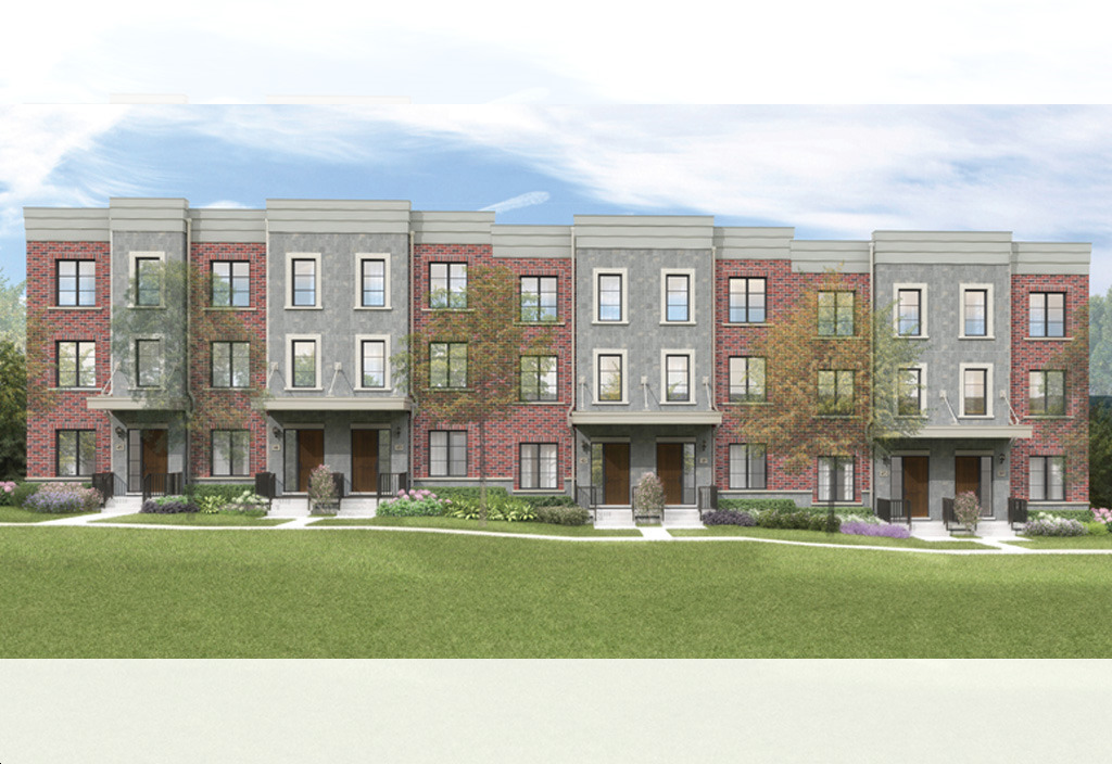 Row of modern brick townhouses with landscaped lawn